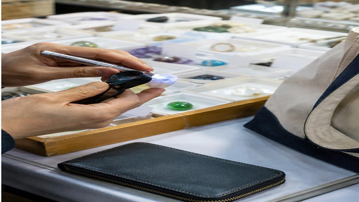 ルーペとライトで天然石を確認しながら価格を比較している写真